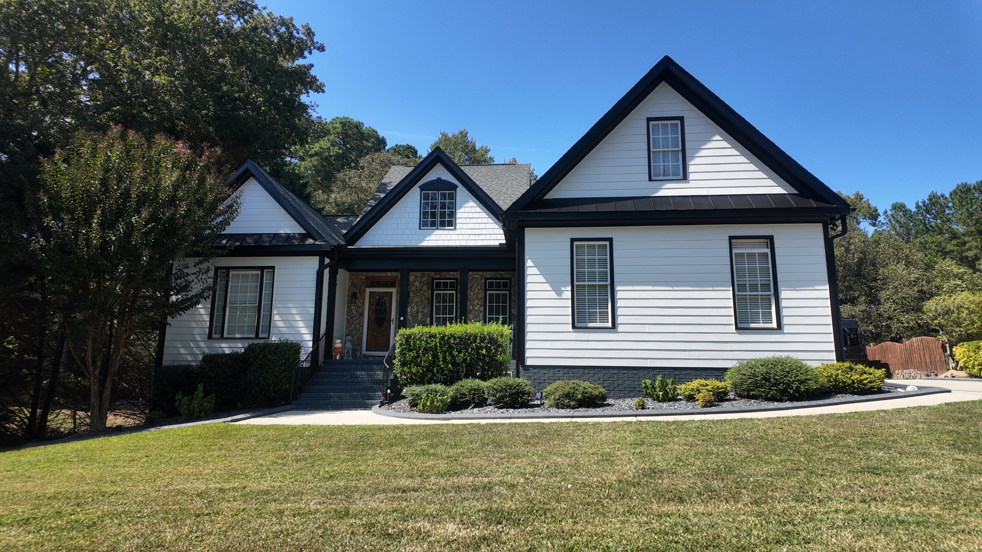 White siding with black trim, prepped and repainted end to end.